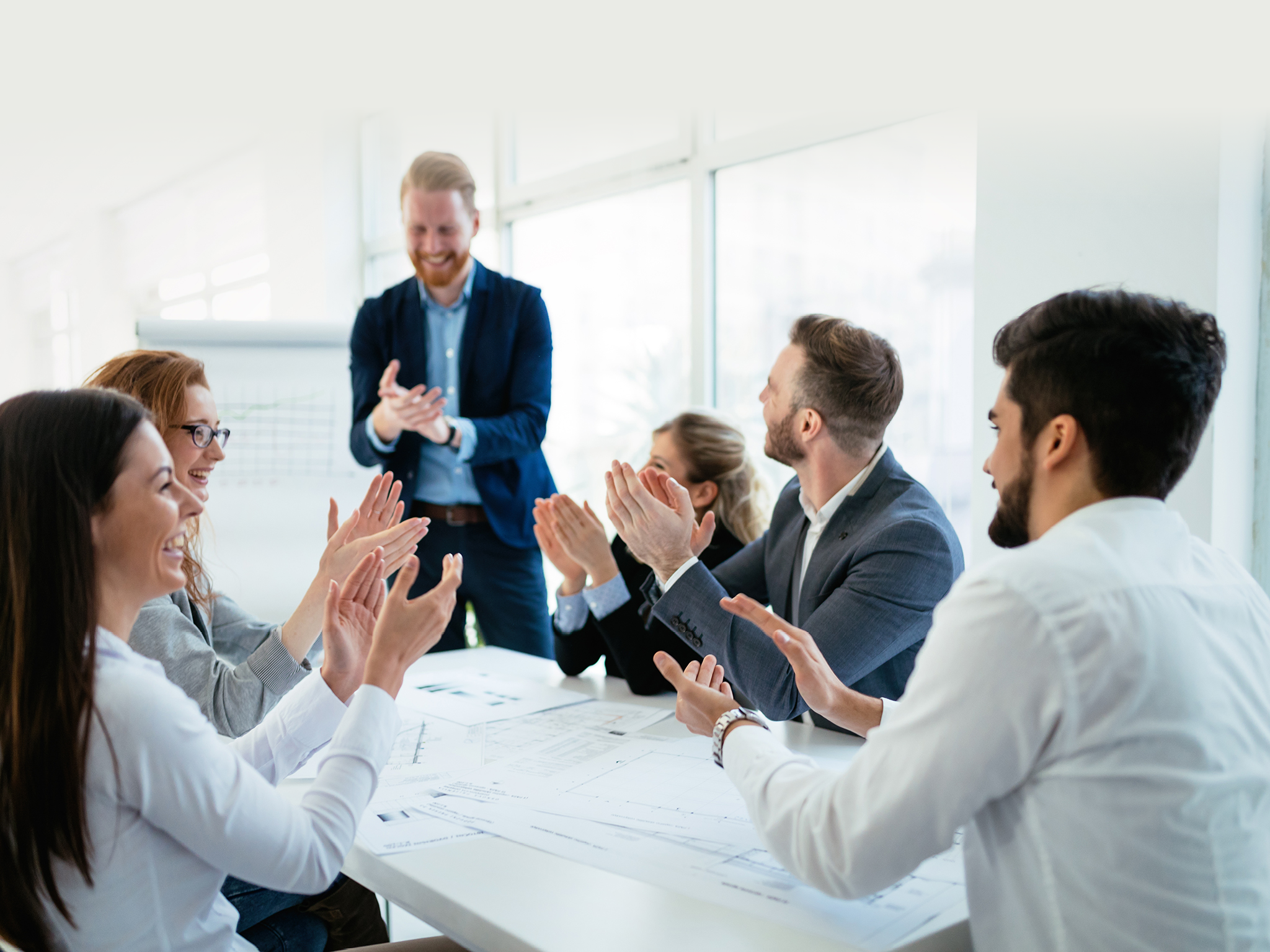 Happy business people celebrating success at company