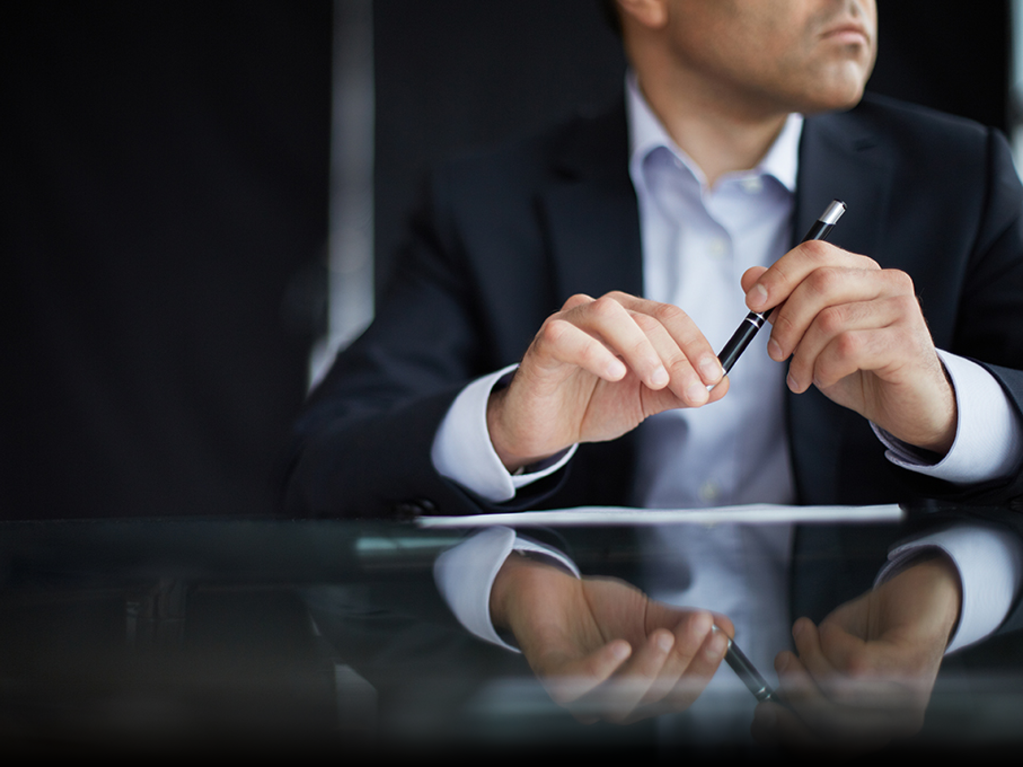 Close-up of male hands with pen