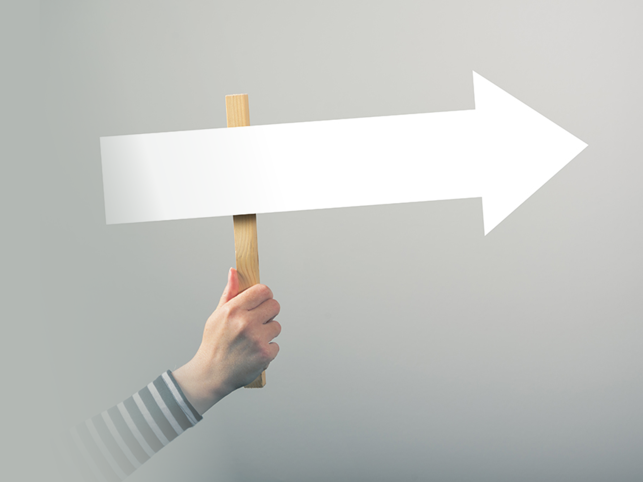Woman holding guiding direction arrow sign in hand, concept of guidance and decision making