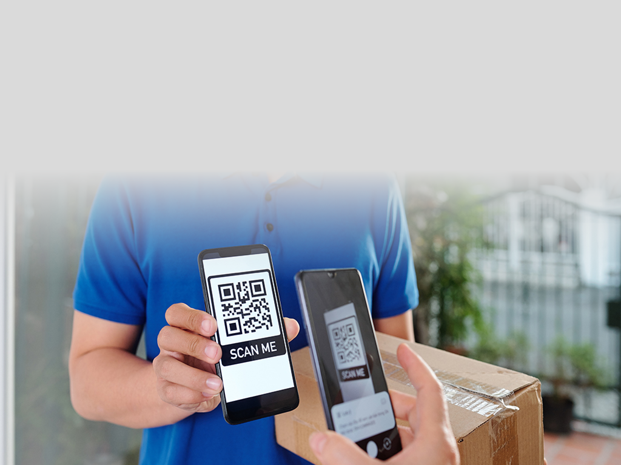 Hands of woman scanning QR code on smartphone of courier and paying for parcel delivery