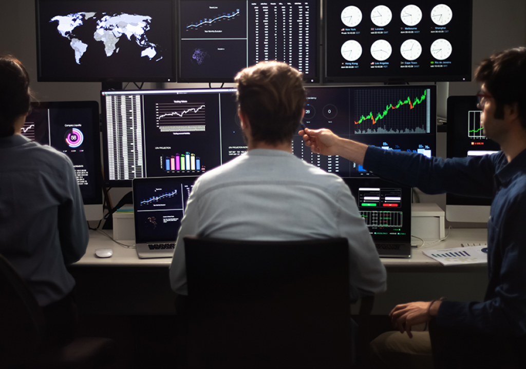 Team of financial analysts working in the office. Stock market and trading concept.