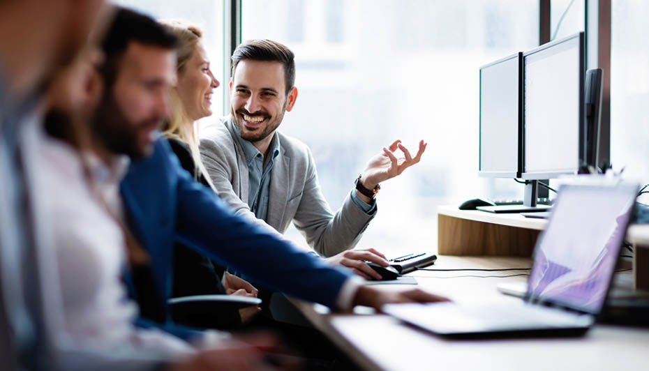 Young businesspeople working on computer in modern office